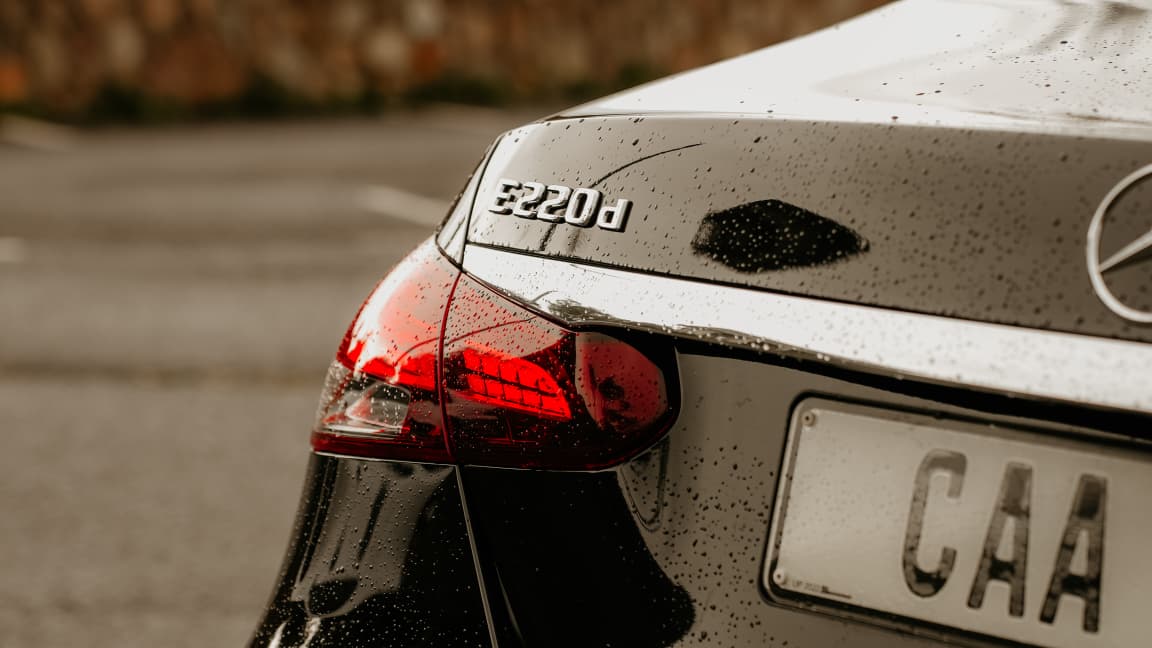 Mercedes-Benz E220d taillight and badge detail with rain droplets